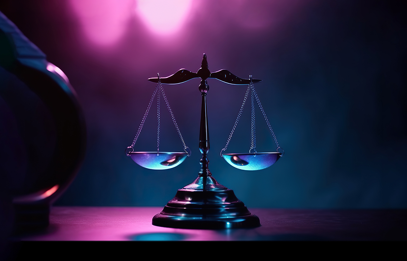 A golden balance scale sitting on top of a wooden table. Justice